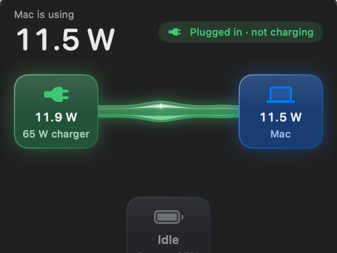 The Wattbar panel: the charger powers the Mac through a glowing green glass tube